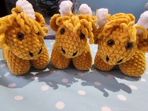 three crochet highland cows